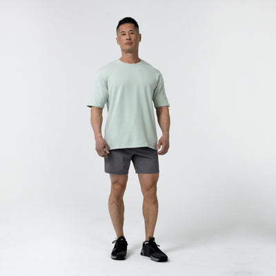 Men's Magnis Heavyweight T-Shirt in Aqua Gray on person with grey shorts on a white background