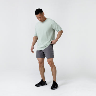 Men's Magnis Heavyweight T-Shirt in Aqua Gray on person with grey shorts on a white background