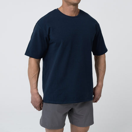 Men's Magnis Heavyweight T-Shirt in Navy on person with grey shorts on a white background