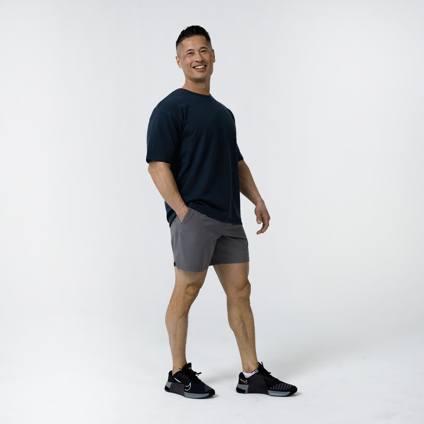 Men's Magnis Heavyweight T-Shirt in Navy on person with grey shorts on a white background