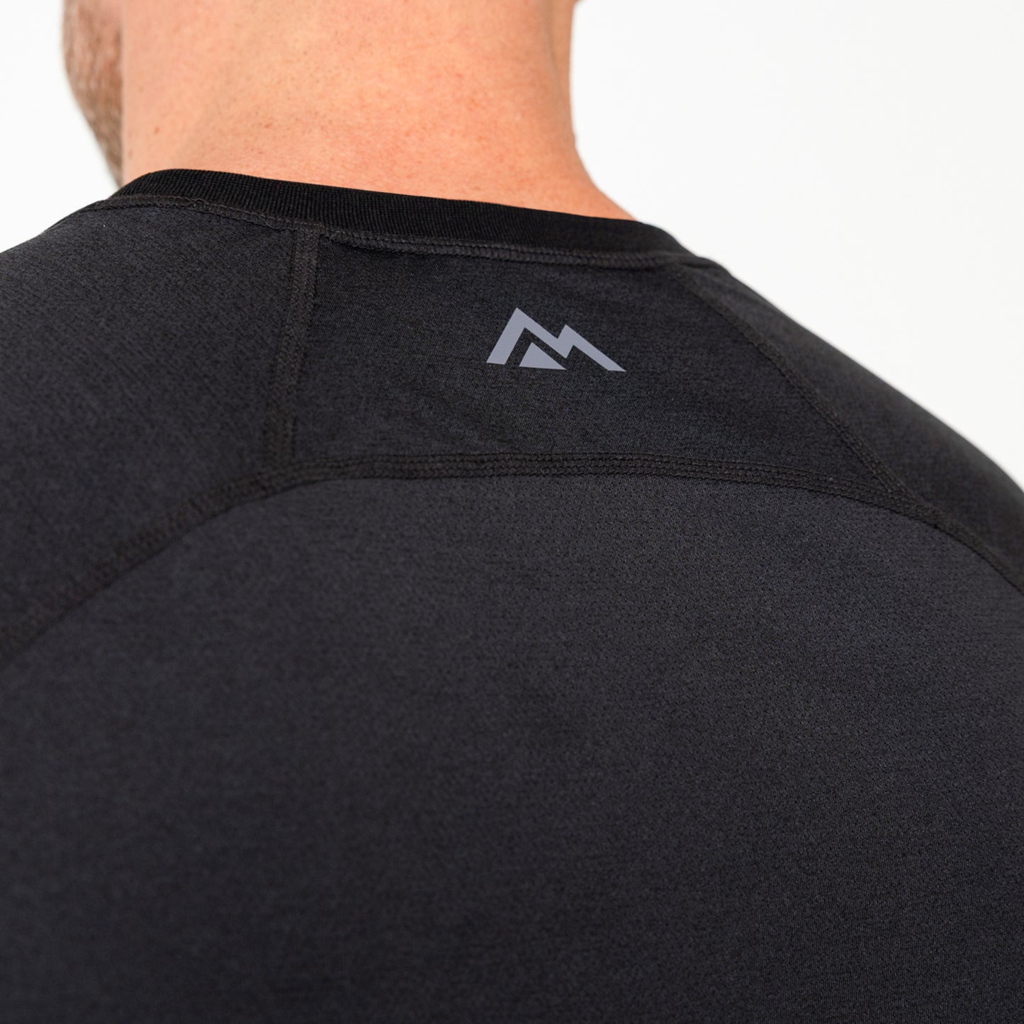 Men's Aerix black athletic shirt with a logo on the back against a neutral background