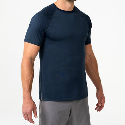 Person wearing a navy Men's Aerix athletic shirt and shorts on a white background