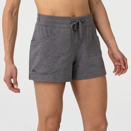 Person wearing gray Women's Vellus athletic shorts on a plain background. 
