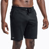 Front view of model wearing the heather black REP Attis Shorts.