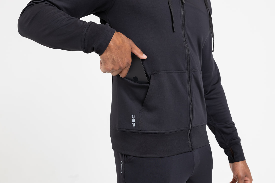 The REP Fitness Men's Attis Jacket in Heather Black front, hidden side-pocket detail