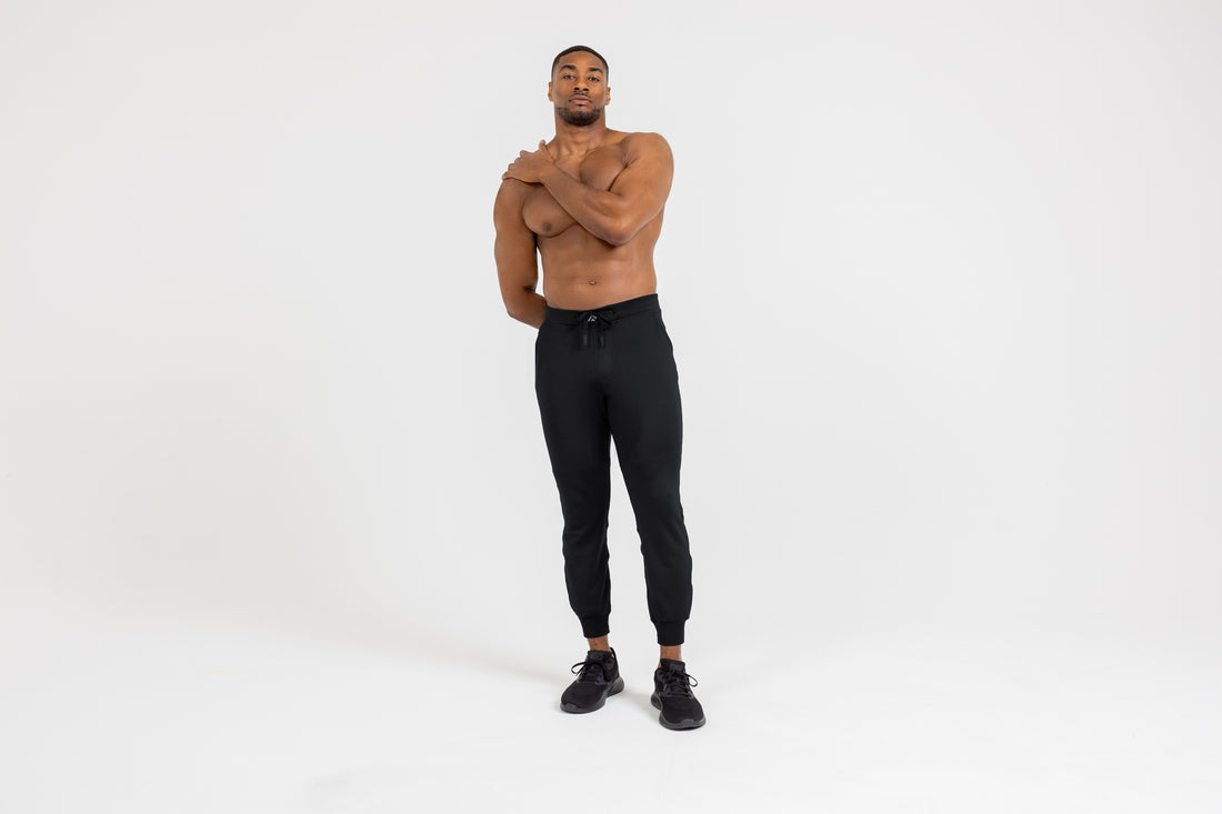 The REP Fitness Men's Attis Joggers in Heather Black front, arms crossed
