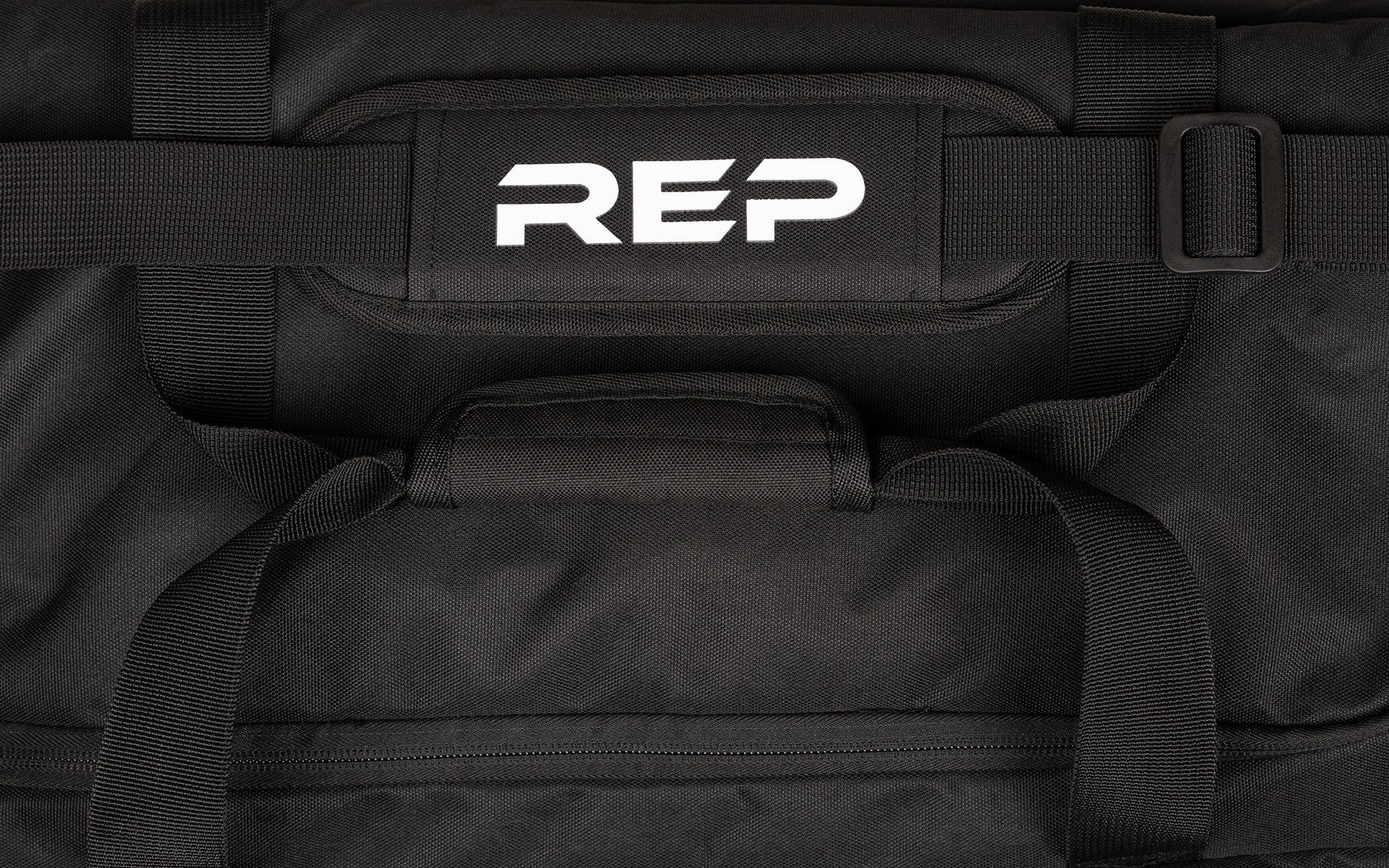 Black shoulder strap with white REP logo on the pad, along with black carrying handles