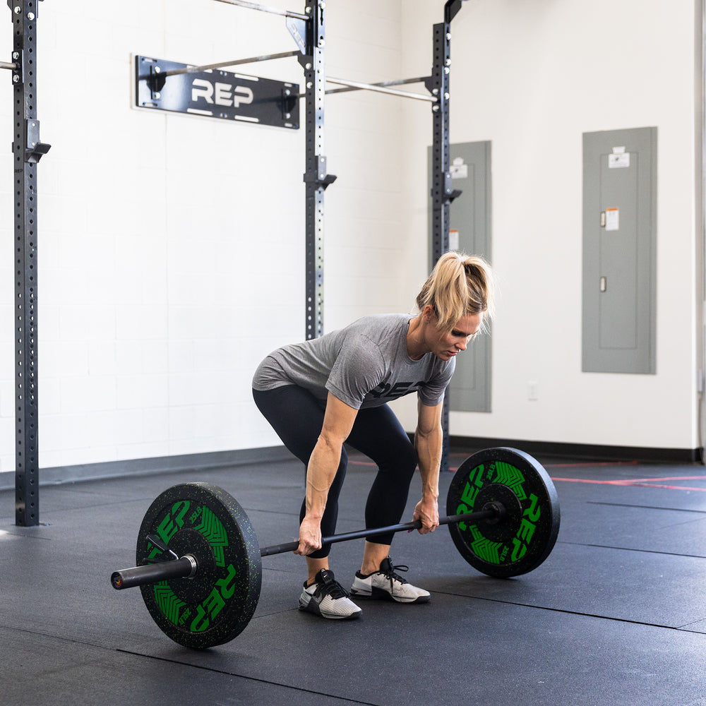 Female lifter in starting position of a deadlift using a REP 15kg Colorado Bar loaded with a pair of 25lb REP Pinnacle Plates.