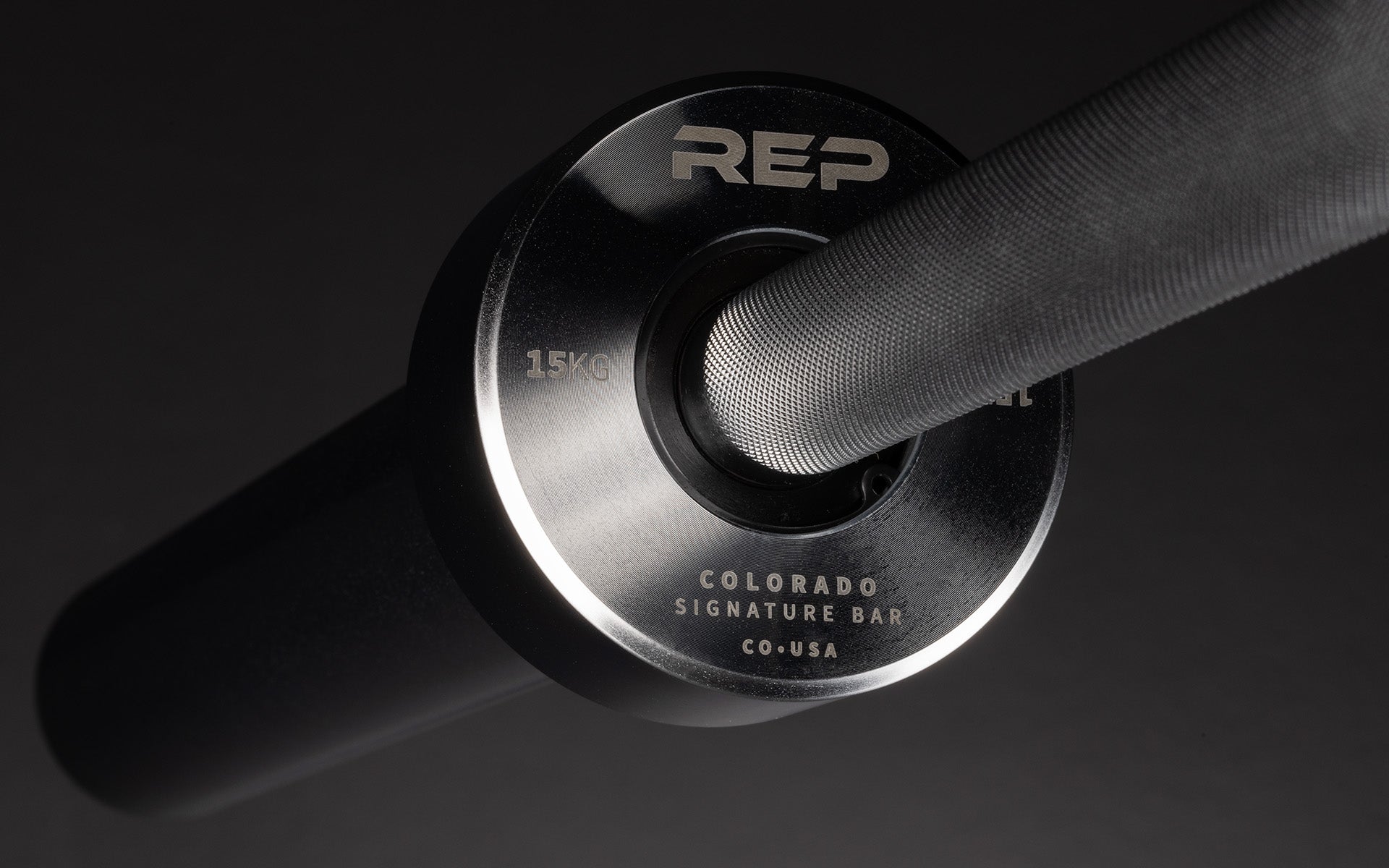 Close-up view of the laser-etched labeling on the inside of the sleeve of a REP 15kg Colorado Bar.