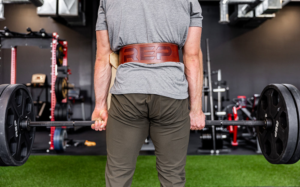 Athlete performing a deadlift while wearing a brown REP Premium Leather Lifting Belt.