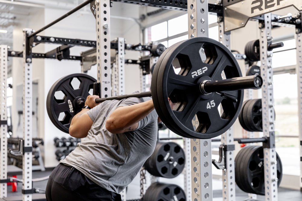 Lifter setting up to perform a back squat using a Black Diamond Power Bar.