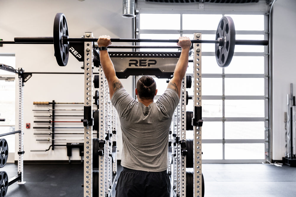 Lifter performing a shoulder press using a Black Diamond Power Bar.