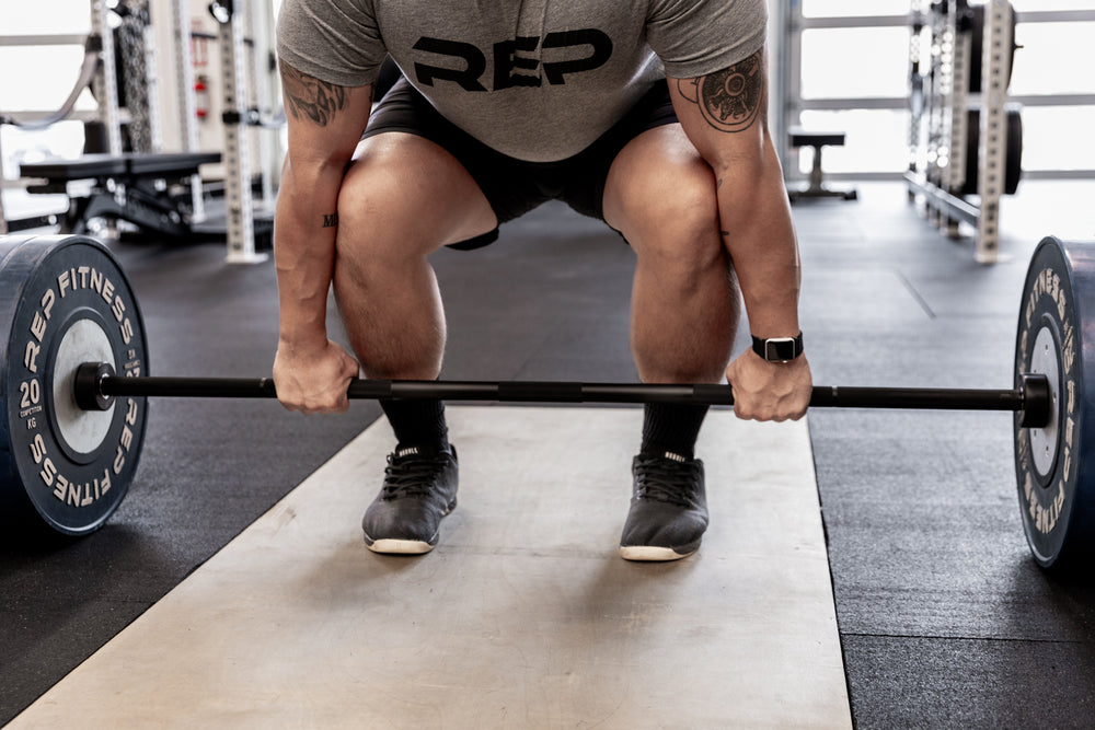 Lifter setting up to perform a deadlift using a Black Diamond Power Bar.