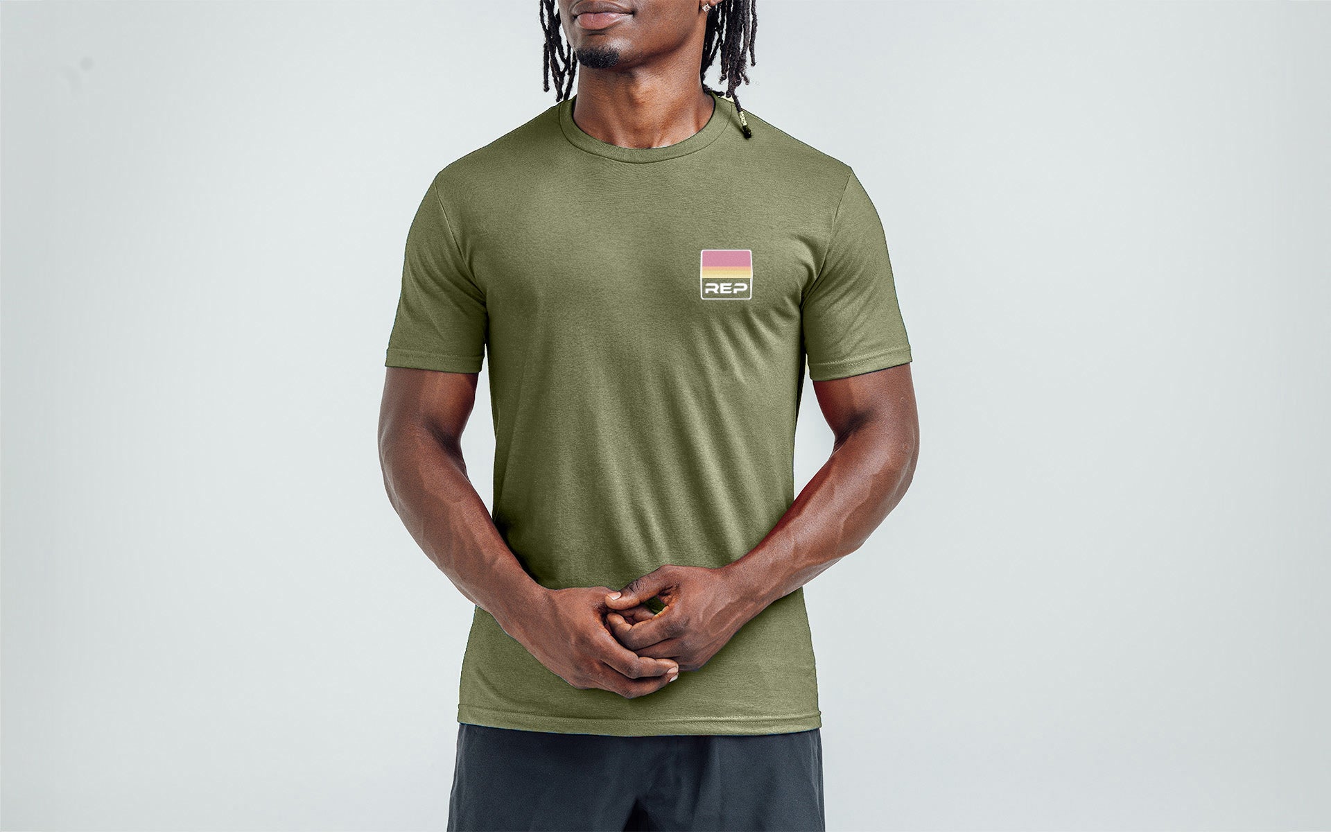 An athlete wearing the REP Fitness Rise Tri-Blend Crew T-Shirt in Heather Navy and Blue