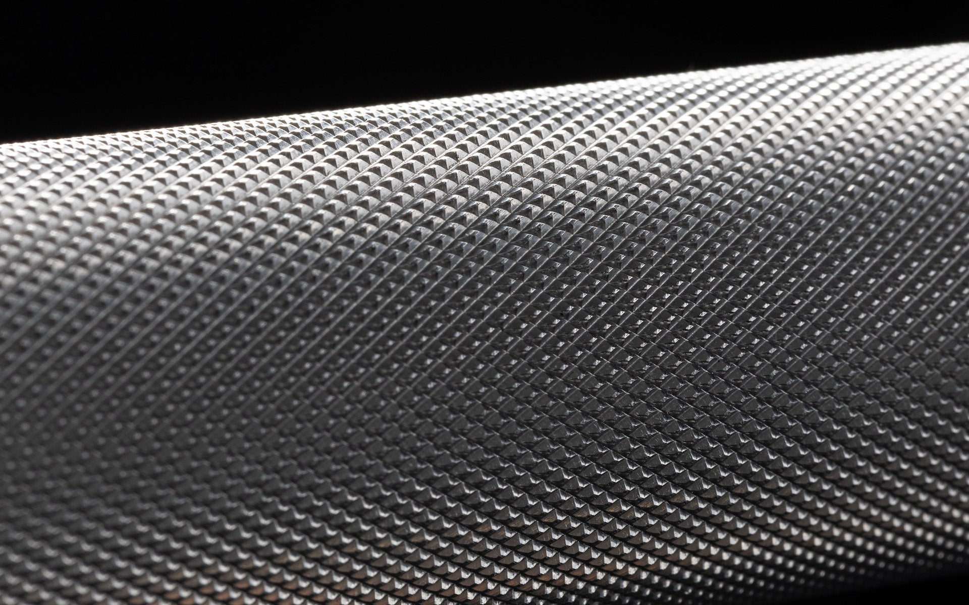 Close-up view of the volcano knurling of the REP 20kg Colorado Bar.