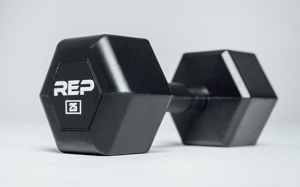 Angled view of a 25lb Rubber Coated Hex Dumbbell showing off the white "REP" logo and weight marking.