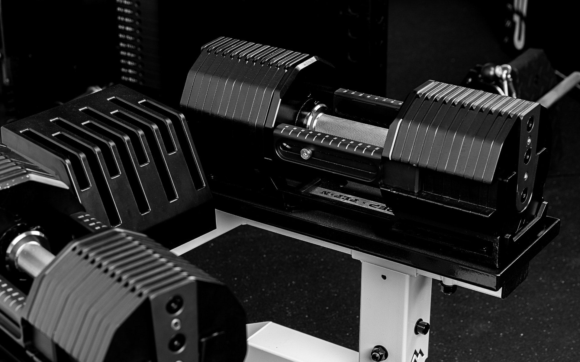 REP® x PÉPIN™ FAST Series™ Adjustable Dumbbells sitting on the REP Adjustable Dumbbell Stand