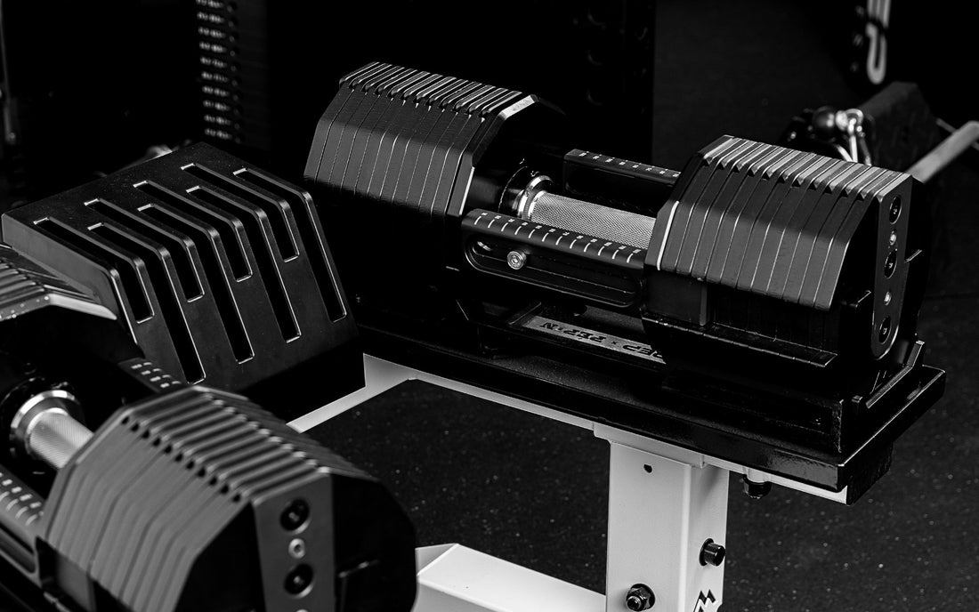 REP® x PÉPIN™ FAST Series™ Adjustable Dumbbells sitting on the REP Adjustable Dumbbell Stand