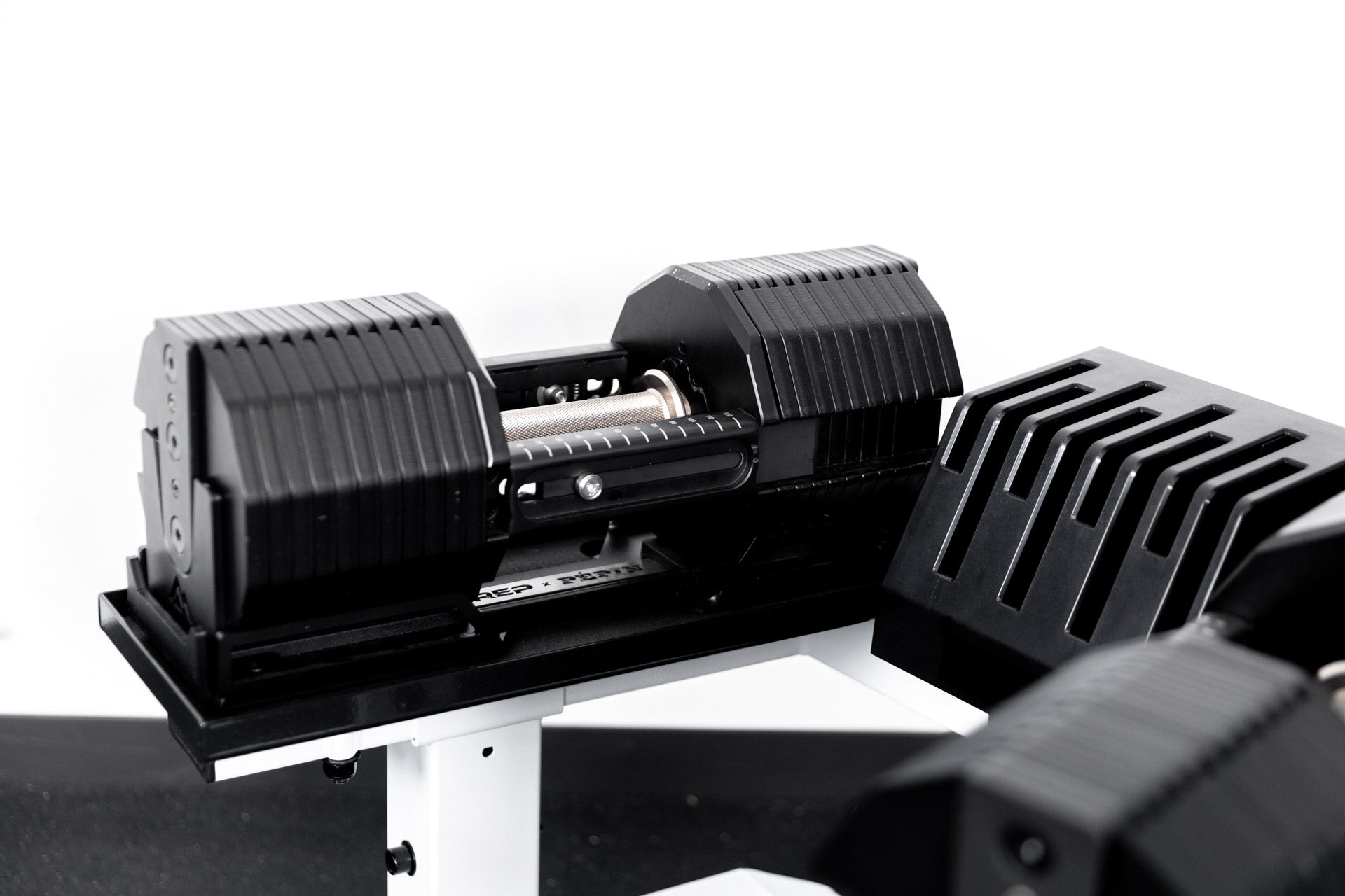 REP® x PÉPIN™ adjustable dumbbells on  a white REP® Adjustable Dumbbell Stand