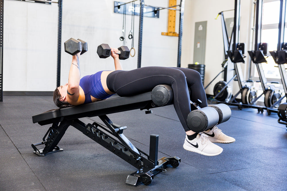 Athlete decline dumbbell bench pressing with the Adjustable Bench Leg Roller Attachment 2.0