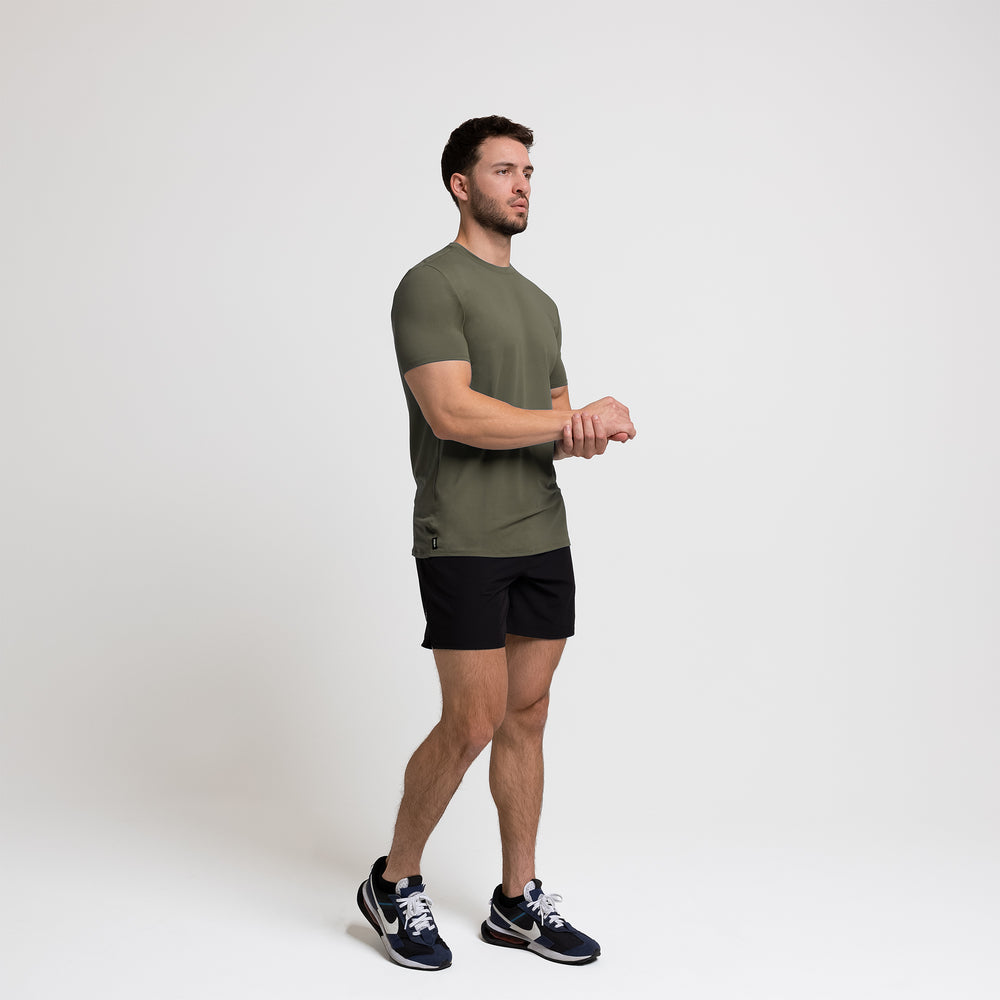 Athlete wearing a olive REP Men's Delta Tee.