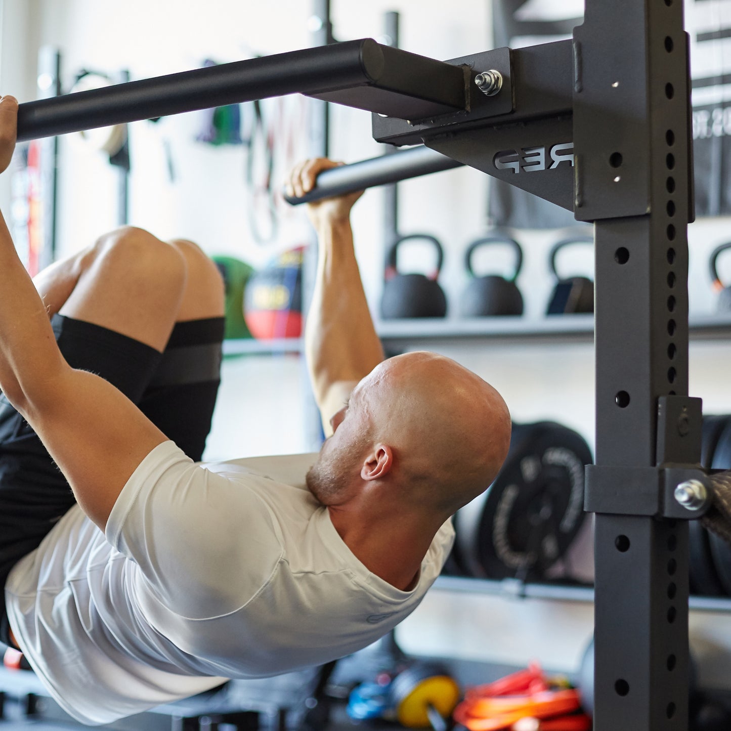 Athlete hanging from the REP Fitness Dip Station for the 4000 series