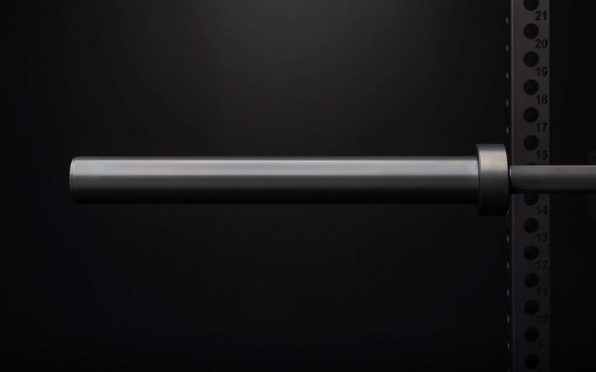Close-up view of the smooth sleeve of a racked REP Double Black Diamond Power Bar.
