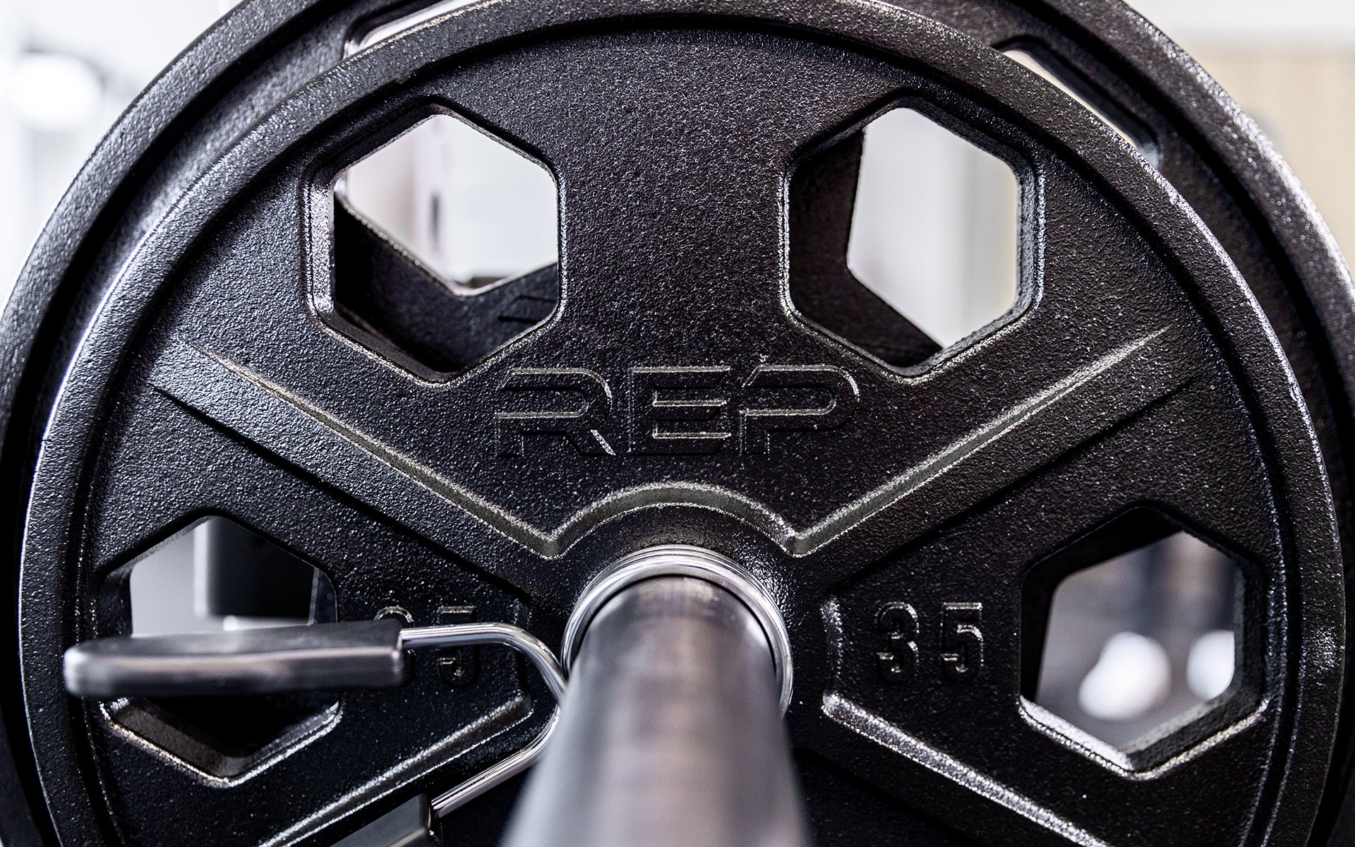 Close-up view of a 35lb USA-Made Equalizer Iron Plate loaded on a barbell.