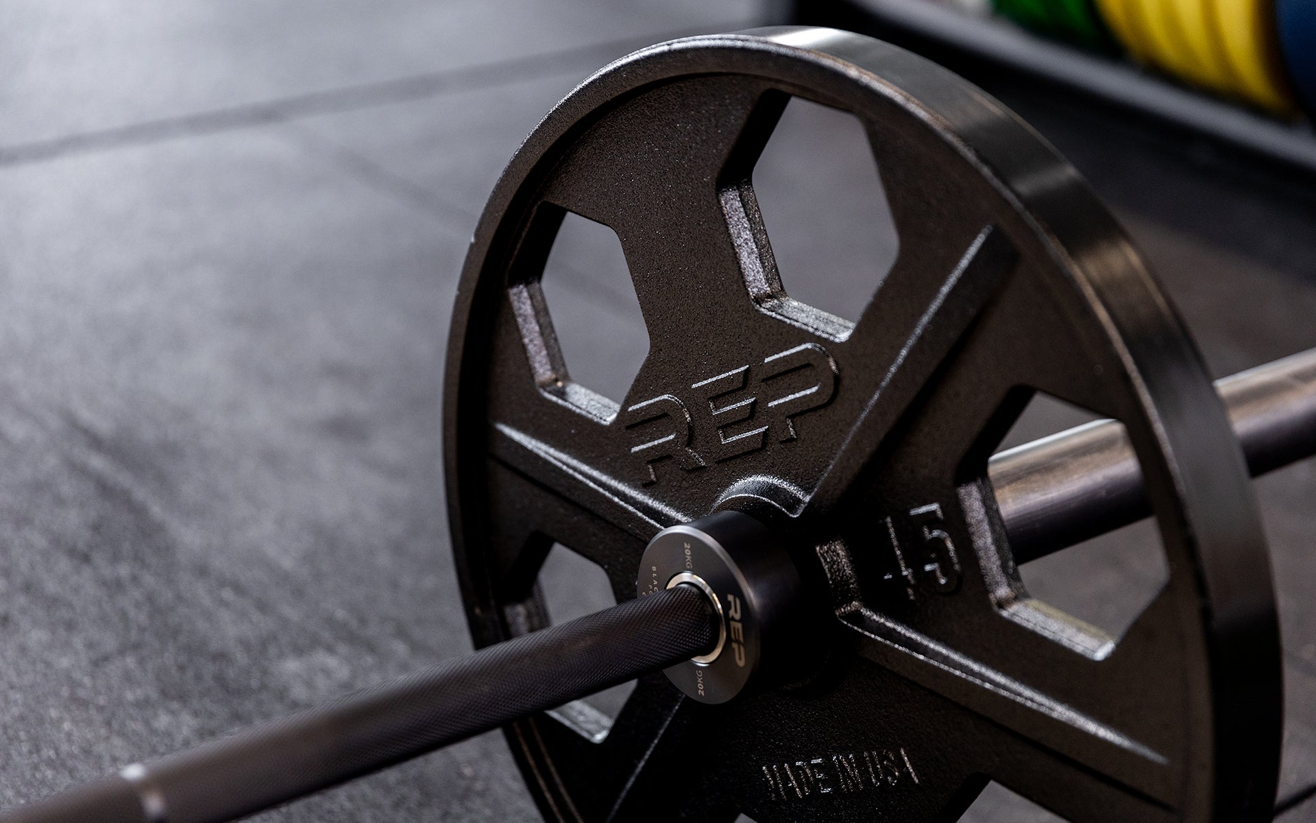 Close-up view of a 45lb USA-Made Equalizer Iron Plate loaded on a barbell.