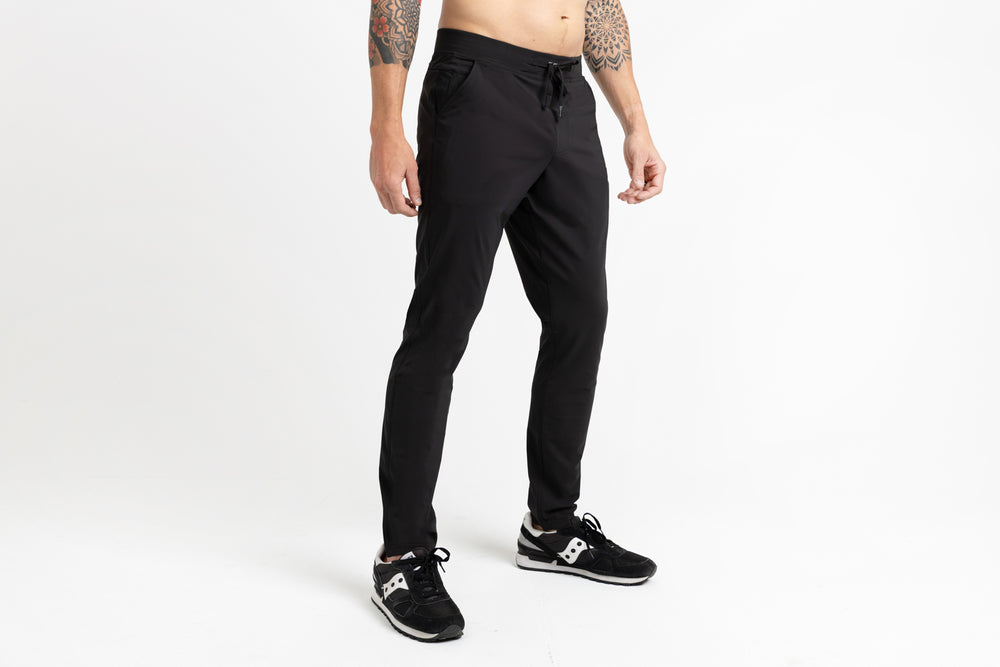 Athlete posing in black Men's Felix Pants 2.0