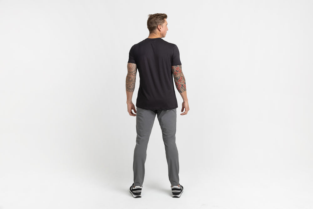 Rear shot of an athlete posing in grey Men's Felix Pants 2.0