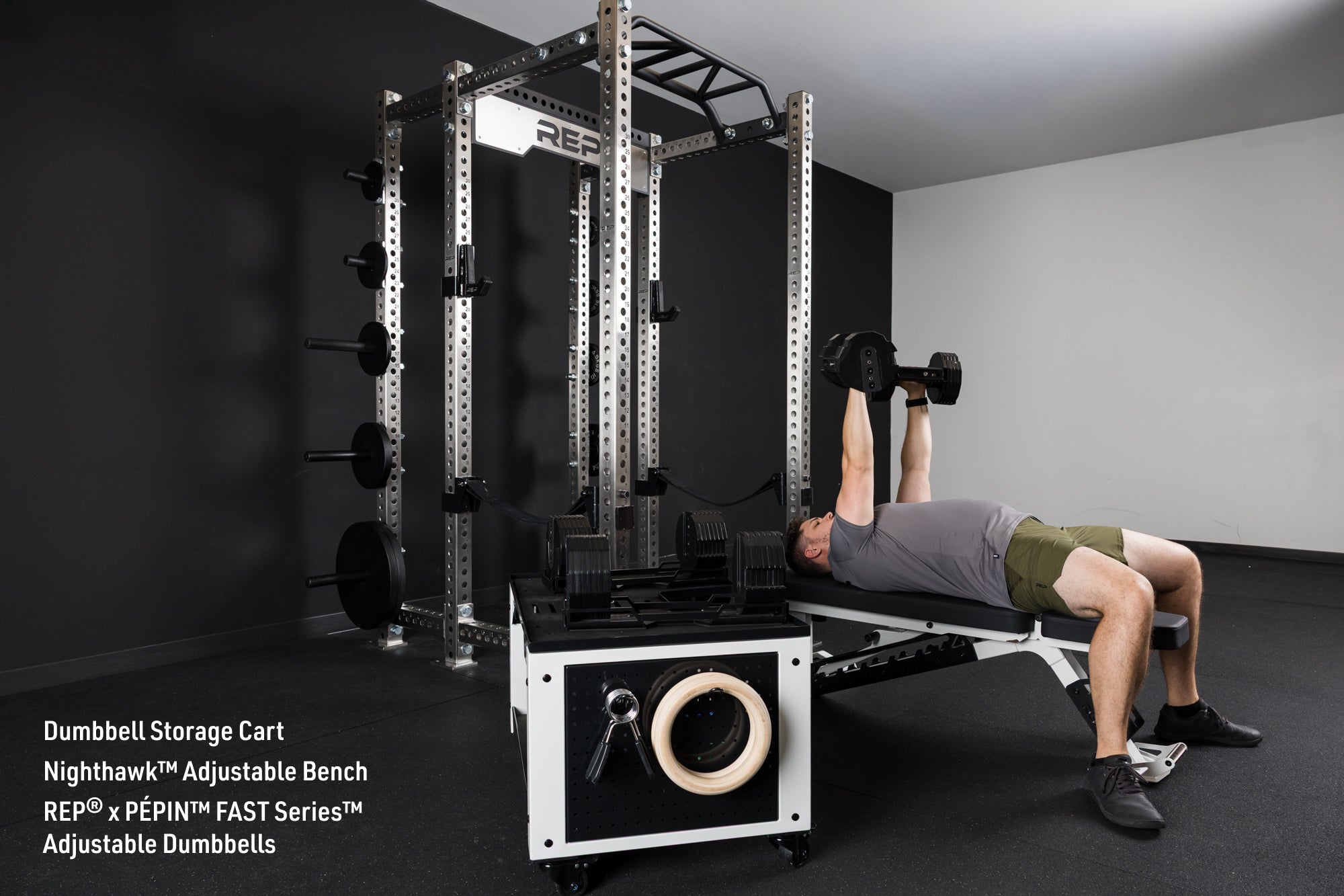 An athlete bench pressing the REP® x PÉPIN™ FAST Series™ Adjustable Dumbbells on the Nighthawk adjustable bench