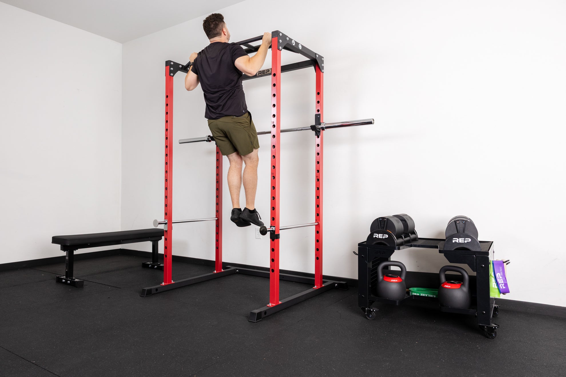 An athlete doing pull-ups on the multi-grip pull-up bar on the PR-1100 rack