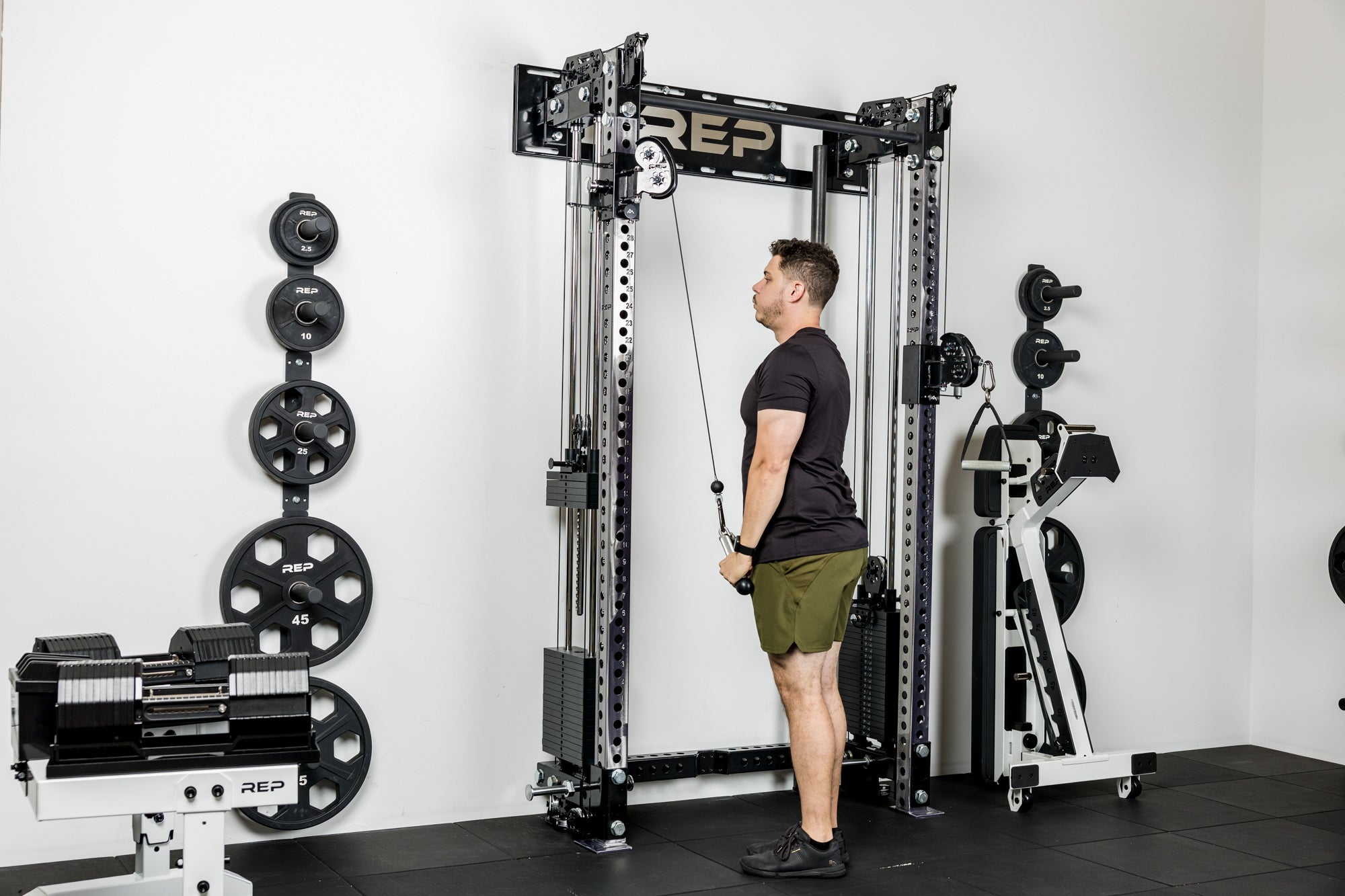 An athlete doing tricep pulldowns with the cable system on the Wall-Mounted Athena