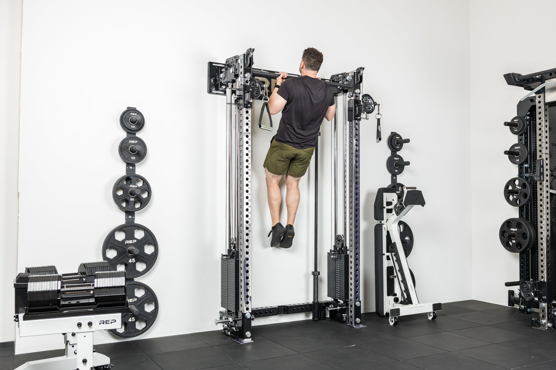 An athlete doing pull-ups on the Wall-Mounted Athena rack system