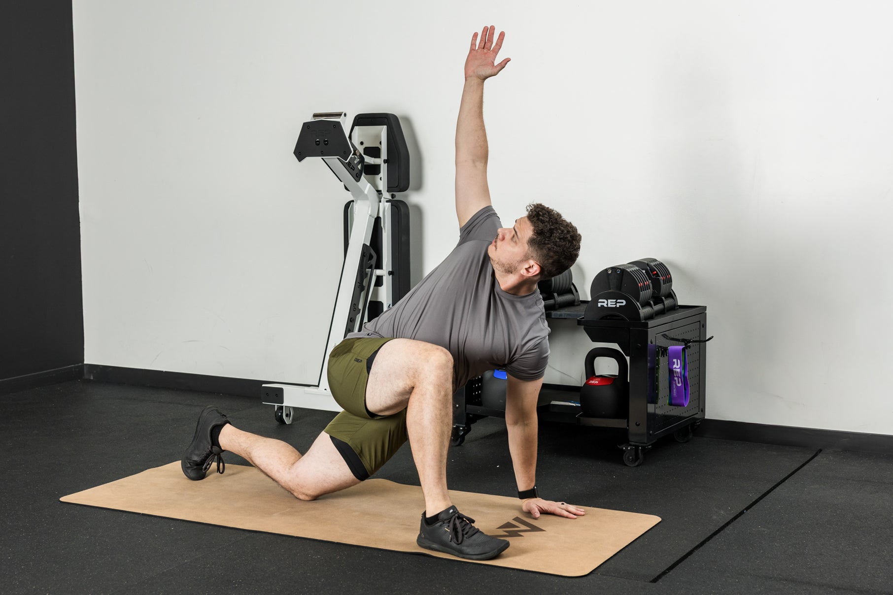 An athlete stretching on the REP premium cork yoga mat