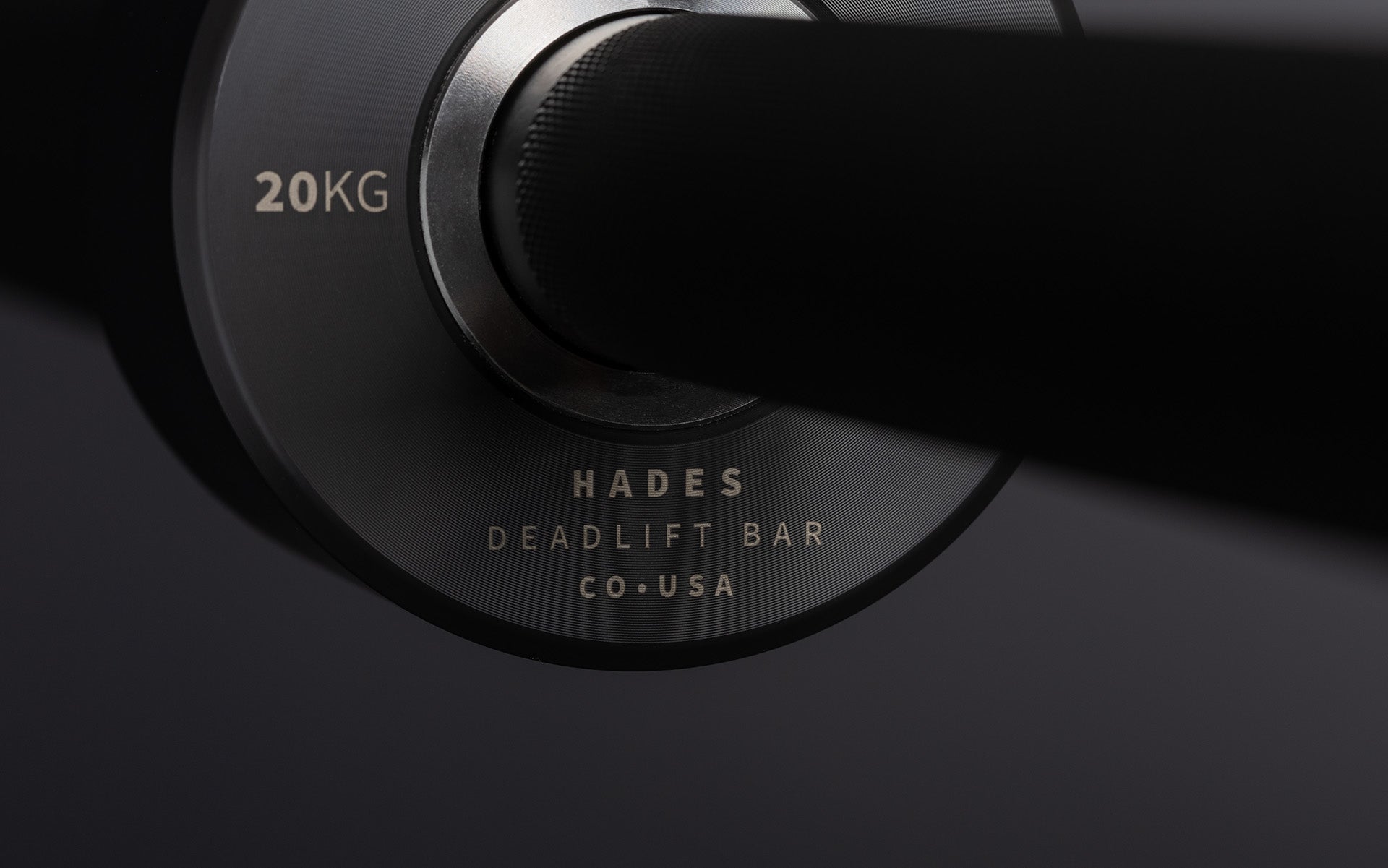 Close-up view of the laser-etched labeling on the inside of the sleeve of a REP Hades Deadlift Bar.
