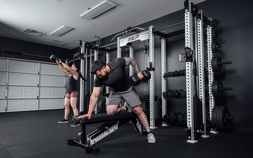 2 athletes using Dumbbells and Kettlebells in front of Hyperion series 1.