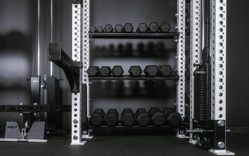 Close-up of right side of the Hyperion series 1 featuring dumbbell storage, spotter arms, and the Athena weight stack.