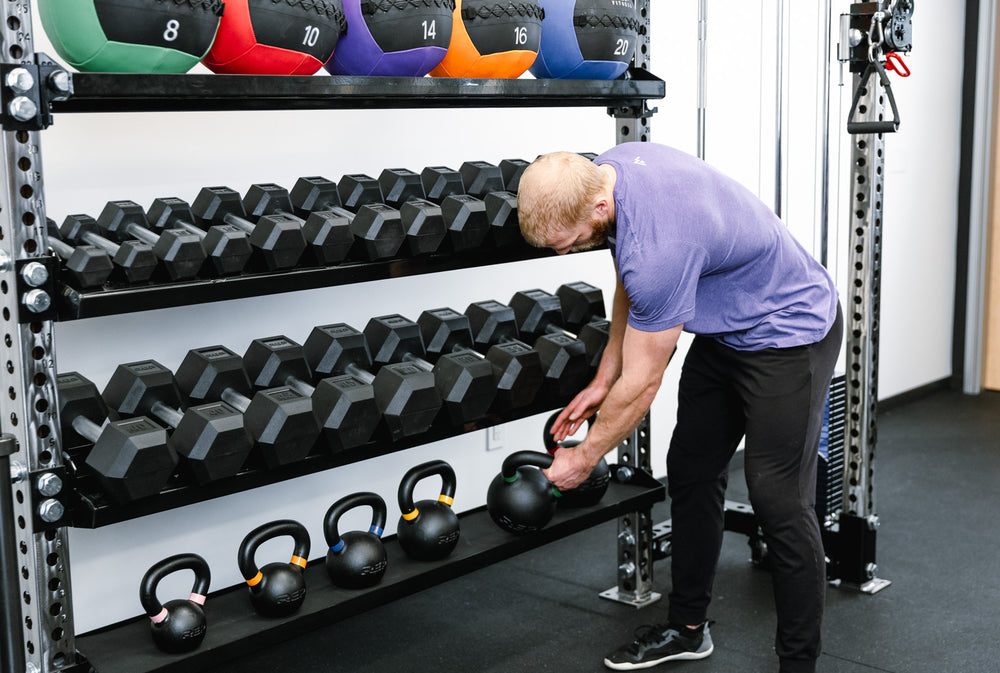 Functional Trainer With Storage - Showing kettlebells, dumbbells, and medicine balls being stored on shelves