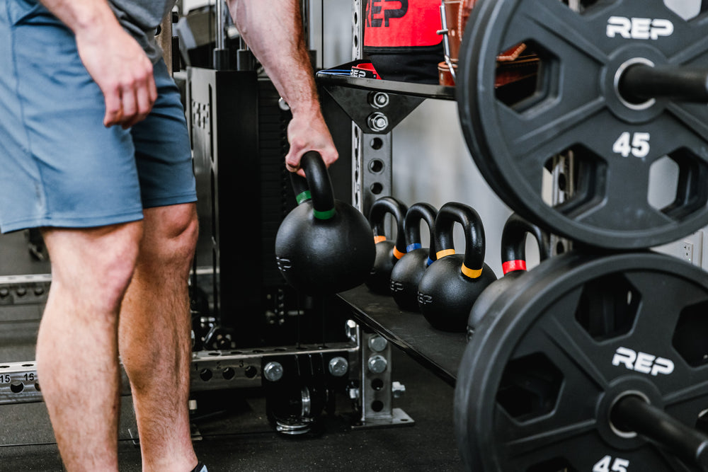 Off-Rack Storage - Showing someone grabbing a kettlebell off of the Flat Storage Shelf