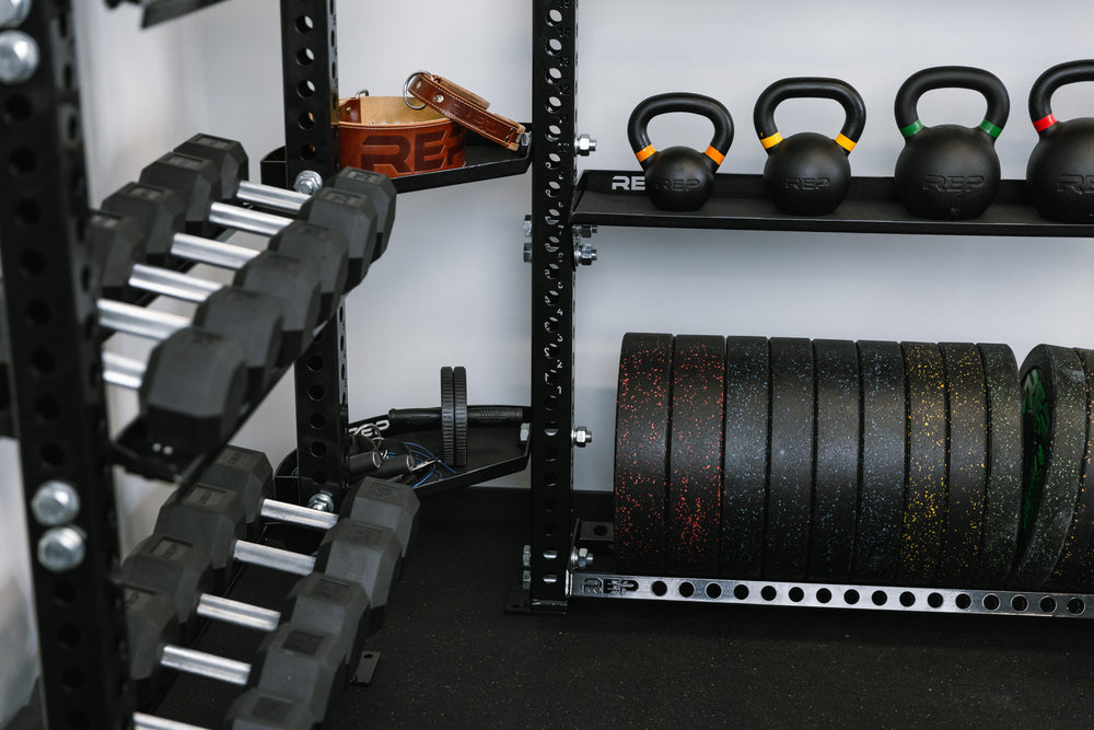 Stand-Alone Modular Storage System. Close up of Corner Shelf Unit holding dumbbells, kettlebells, bumper plates,  and small accessories