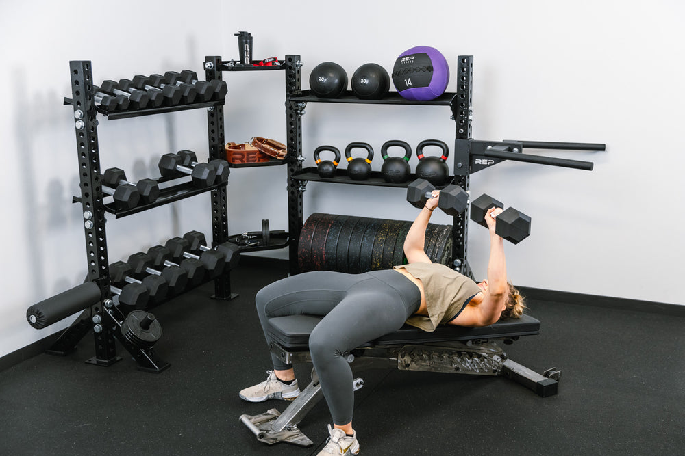 Stand-Alone Modular Storage System. Corner Shelf Unit holding dumbbells, slam balls, medicine balls, kettlebells, bumper plates, attachments, and small accessories