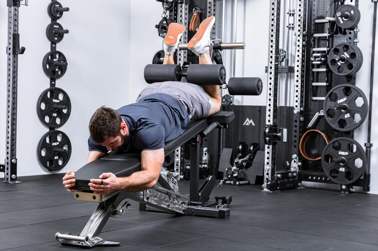 Athlete using cable resistance to do hamstring curls on theLeg Extension & Leg Curl Bench Attachment