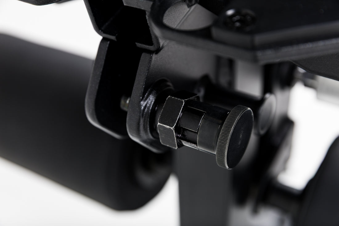 Close up of the lock-pin mechanism on the Leg Extension & Leg Curl Bench Attachment