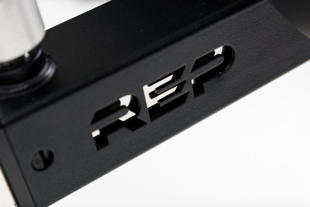 Close-up shot of the REP branding cutout on the Leg Extension & Leg Curl Bench Attachment