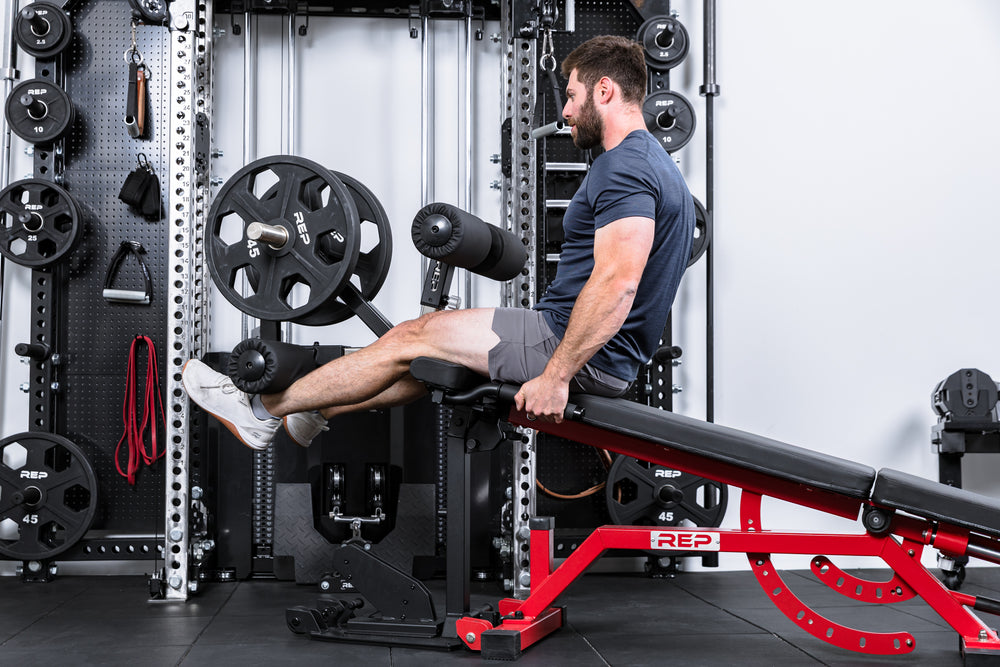 Athlete doing Leg Extensions on the Leg Extension & Leg Curl Bench Attachment on an AB-5000