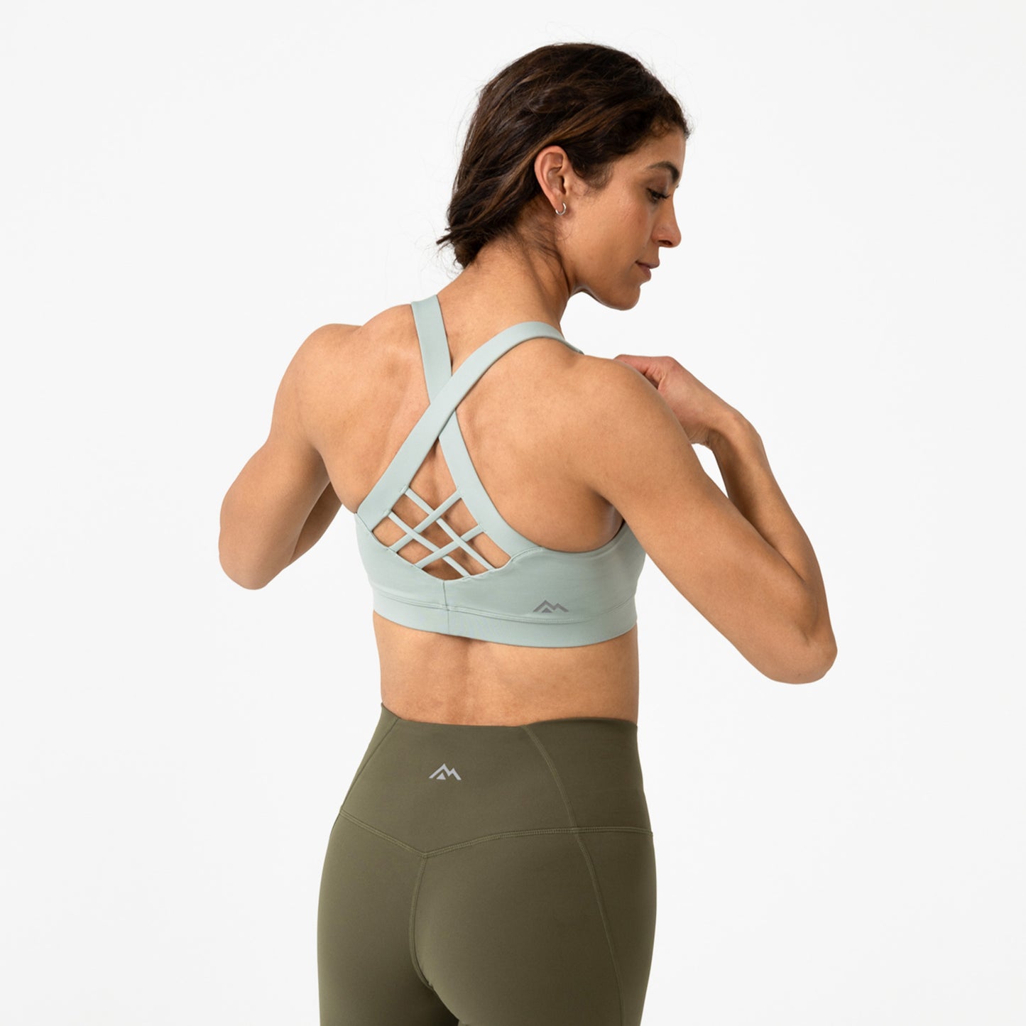 Women wearing the Women's Lattis Bra in Aqua Gray showing off the back of it