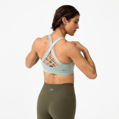 Women wearing the Women's Lattis Bra in Aqua Gray showing off the back of it