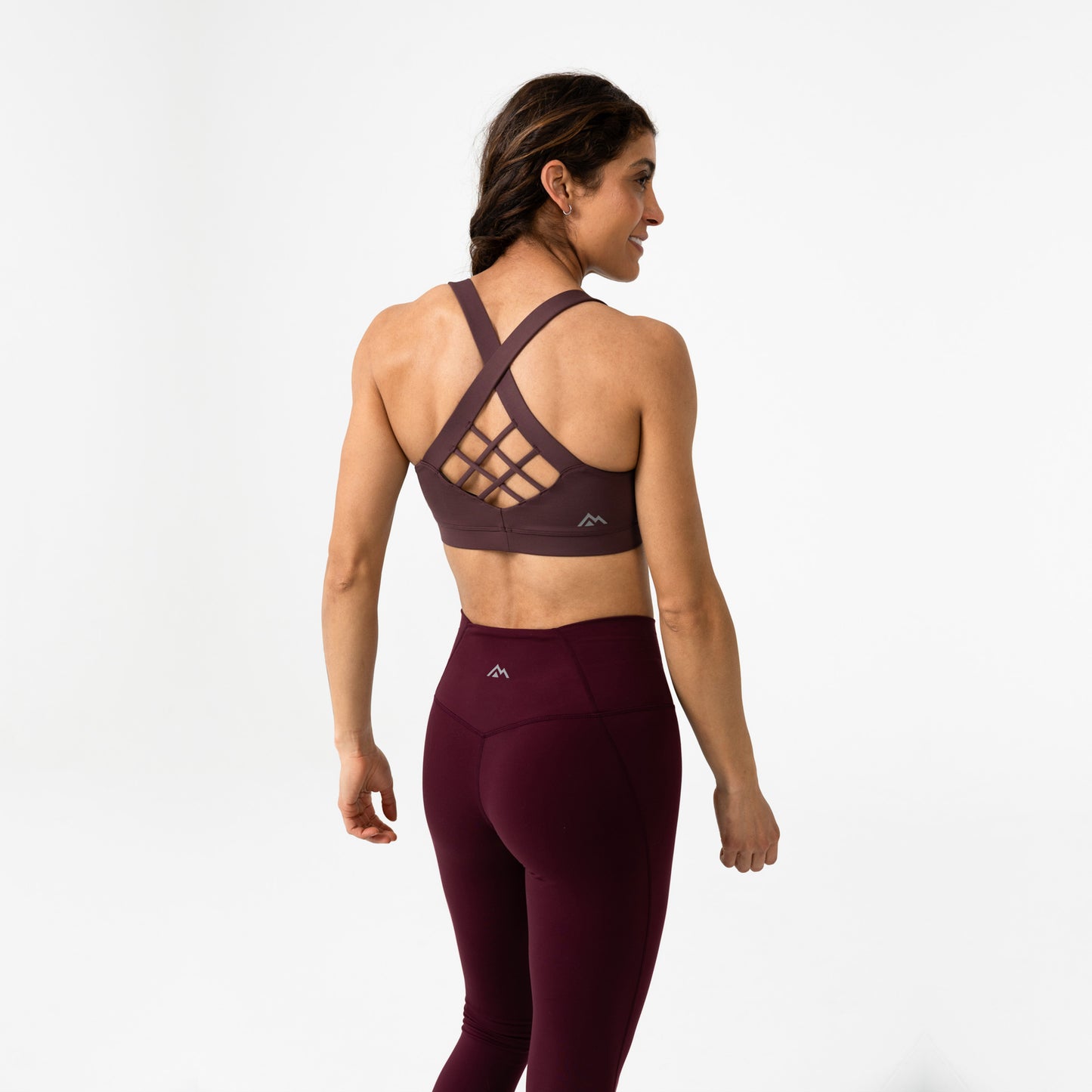 Rear shot of an athlete posing in Cocoa Powder Lattis bra